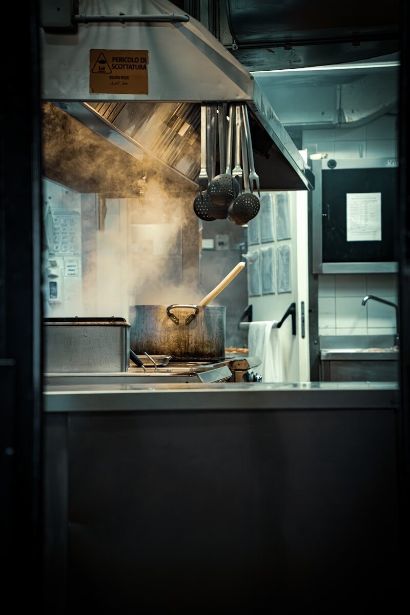 Steam rising from a pot cooking on a stovetop.