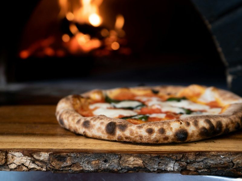 pizza on brown wooden table